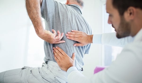 Chiropractor Adjusting Man's Back 