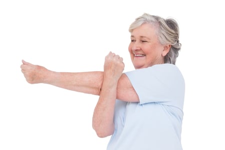Senior woman stretching her arms on white background